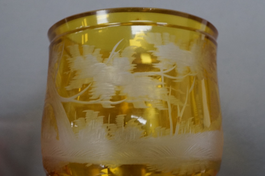 Four Bohemian engraved amber or ruby flashed ‘hunting’ goblets or beakers, late 19th century, tallest 15cm high